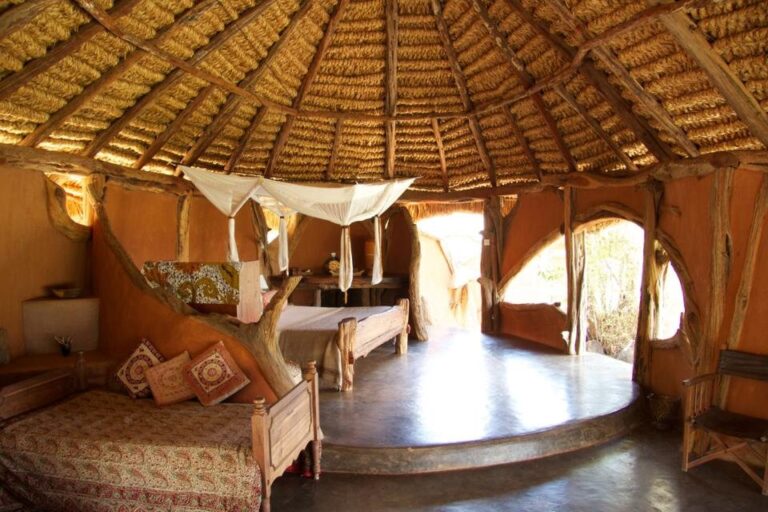 Spacious family room with thatched roof at Tassia Lodge