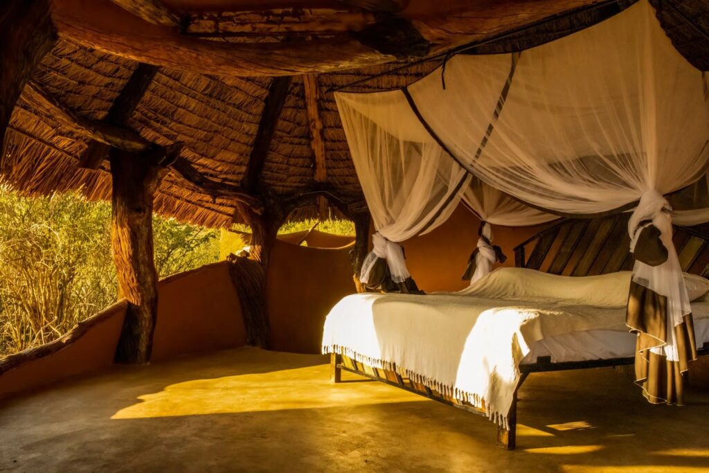 Open-air bedroom at Tassia Lodge in morning light