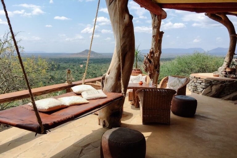 Swing bed on the Tassia Lodge deck with views to the plains